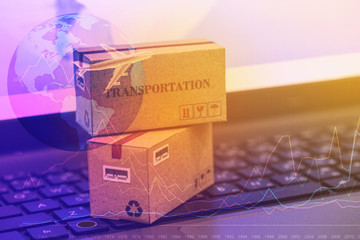 Business concept : cardboard boxes for packing of goods on notebook keyboard. International freight...