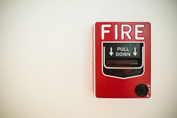 new red fire alarm on white wall