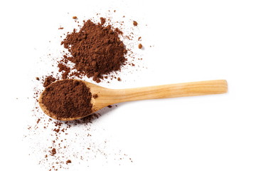 Cocoa powder pile in wooden spoon isolated on white background