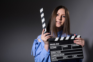 Young woman with movie clapper.