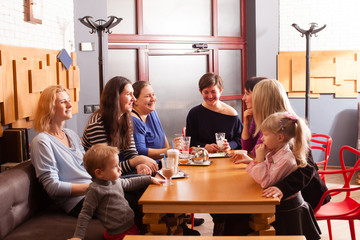 Women and children having a drink