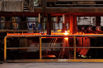 Cutting steel machine in smelting steel plant. Processing of forming deformed bars steel.