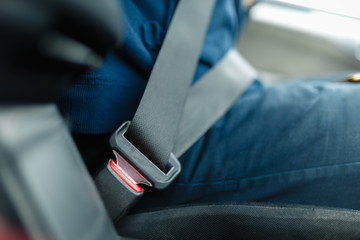 Fastened seat belt of the vehicle. Close the car seat belt, sitting inside the vehicle before driving and have a safe journey.