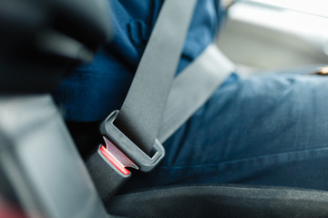 Fastened seat belt of the vehicle. Close the car seat belt, sitting inside the vehicle before driving and have a safe journey.