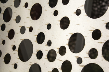 bright metal surface with round holes. abstract background