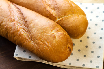 Baguette. Fresh baguette for breakfast. Baguette on the kitchen table.