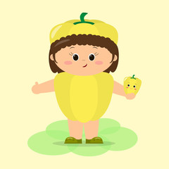 A cute kid in yellow pepper suit is holding a vegetable in his hands.