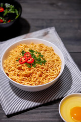 Instant noodles with egg in wooden bowls