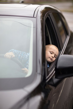 Little Boy Pretending To Drive Car