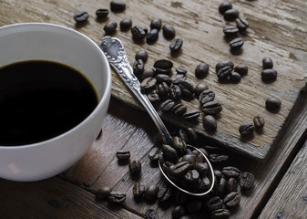 Coffee cup and coffee beans on the table