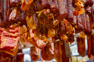 Obraz na płótnie Canvas Selling smoked meat on stall, street market