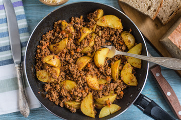 Savory mince and potato wedges in a frying pan - rustic dish