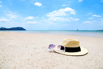 Panama hats and sunglasses On the beach Copy space