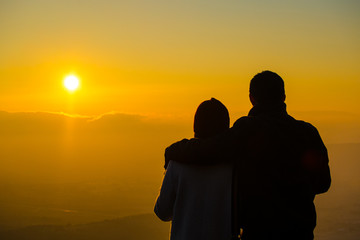 Silhouette of couple watching sun rise