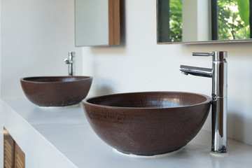 Chrome water taps in washroom with classic contemporary style sinks