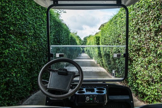Image from back seats of golf car, service in golf resort to escort guests to rooms