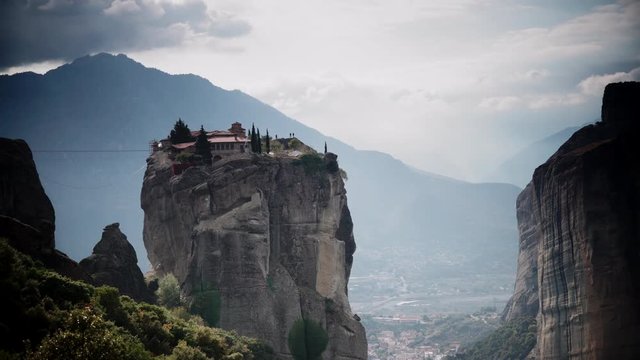 Cloudy sky over holy Trinity monastery on cliff in Meteora, Thessaly Greece. Greek destinations. Time lapse