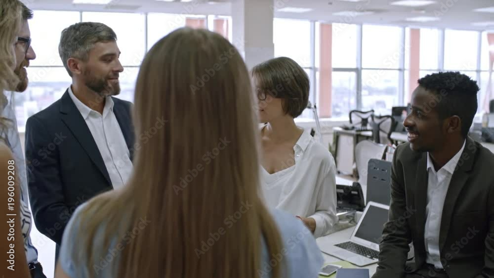Poster group of colleagues standing in circle in office and assigning roles and responsibilities for new pr