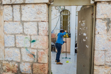 jewish boy cleaning the floor in Jerusalem, Israel