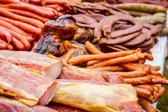 Selling various smoked meat on stall, street market