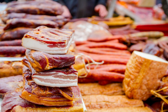 Selling various smoked meat on stall, street market