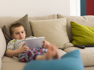 little boy playing games on tablet computers