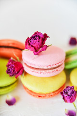 Delicate French Macaroons With Fresh Flowers Roses On Light Background