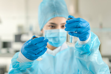 Female scientist looking at the scientific sample in the laboratory