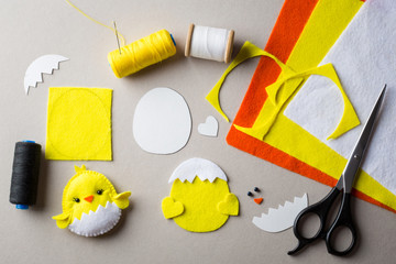 Cut-out details chicken toy. Fabric crafts for kids step by step. How to make a cute felt chick toy. Sewing pattern. Set to create a baby toy. Fun handmade idea