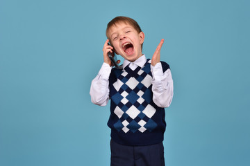 A teenager communicates on a mobile phone. The boy has a telephone. Business conversation.