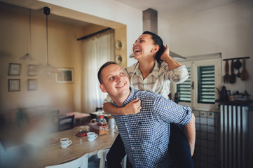 Romantic couple in love spending time together in kitchen
