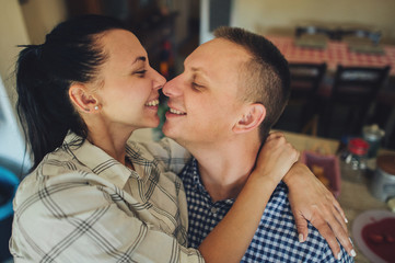 Romantic couple in love spending time together in kitchen