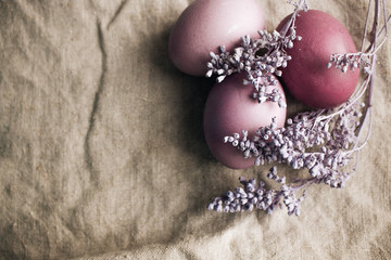 Painted Easter eggs on sackcloth decorated with lavender, rustic festive composition