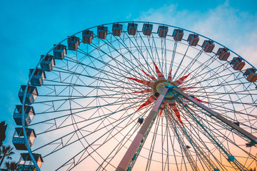 big ferris wheel with blue and orange sky in the background
