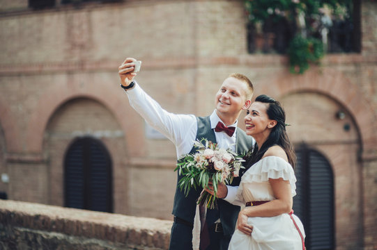 newly wedded couple making selfie after ceremony