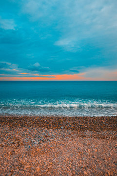 high formated picture of colorful stone beach with cloudy sky