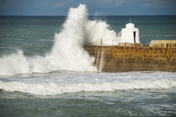 Crashing wave striking a harbour wall