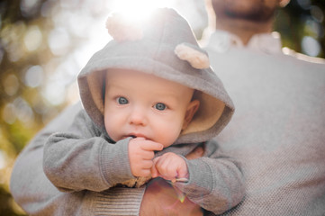 Portrait of a cute baby boy in father hand