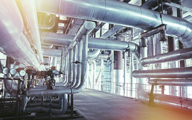 Equipment, cables and piping as found inside of a modern industrial power plant