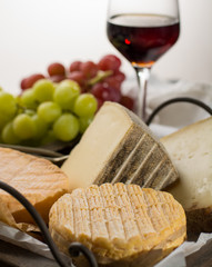 Tasting of oldest french AOC soft pudgent yellow cheese Livarot,  Munster and semifirm Tomme french cheeses