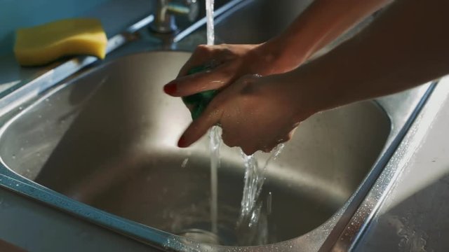 Girl Hands Wring Duster under Water Stream in Sink