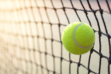 Close up tennis ball hitting to net on blur background