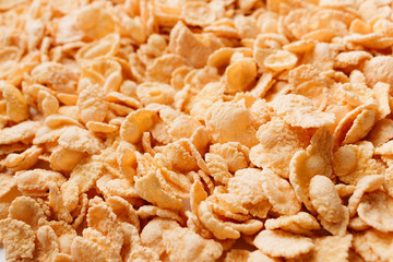 Pile of delicious crispy cornflakes, food background, healthy breakfast