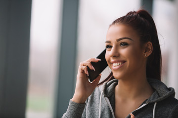 Sporty girl talking on mobile phone.