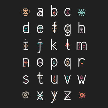 Vector display alphabet. Lowercase letters decorated with color floral patterns on a black background.