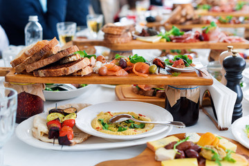 Delicious food. Different meals for the guests on the table in restaurant. Healthy mediterranean cuisine.