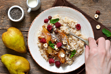 Morning breakfast. Oatmeal, caramelized pear and fried hazelnuts.