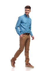 Naklejka premium side view of a happy relaxed casual man walking