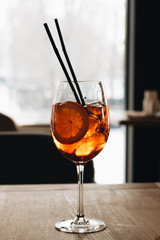 Delicious cocktail with ice cubes on wooden table