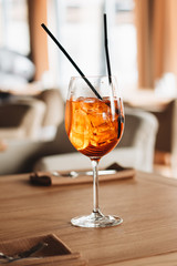 Delicious cocktail with ice cubes on wooden table
